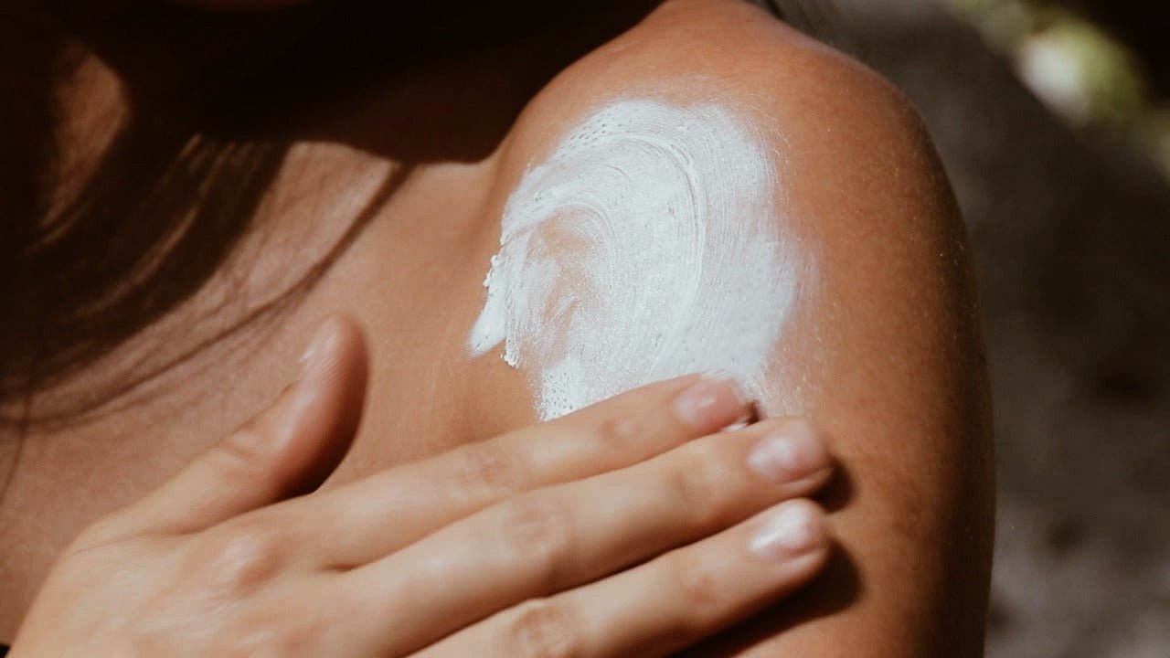 Applying organic zinc oxide tallow sunscreen balm to dry hands to soothe cracked skin and protect against UVA & UVB Rays