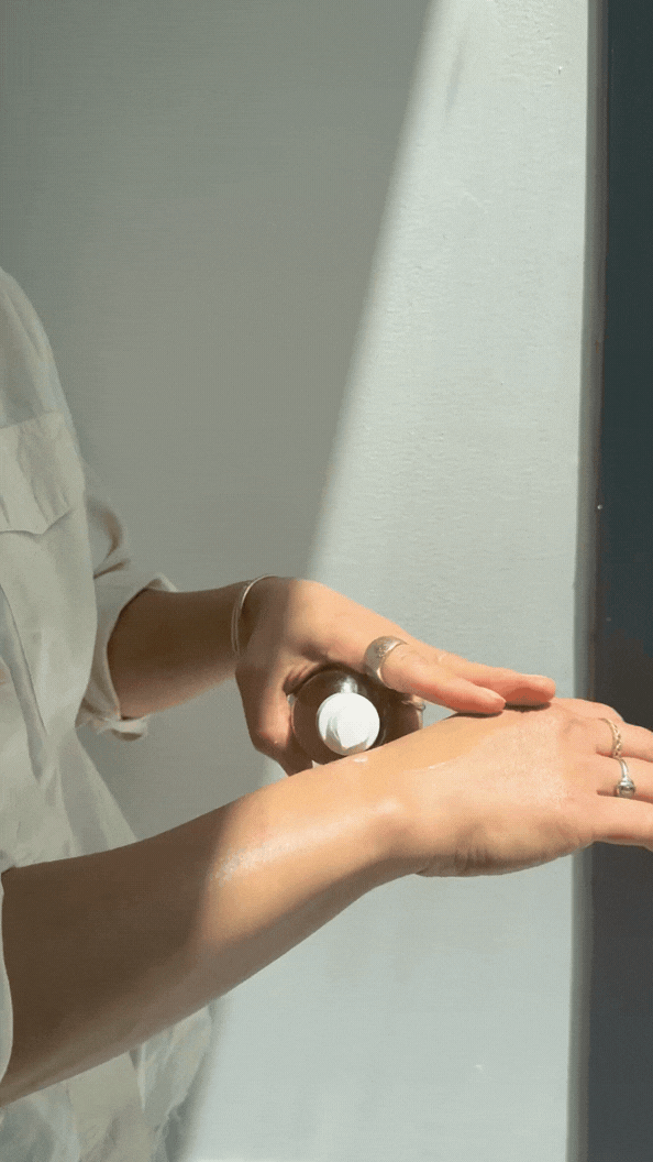 Applying fragrance-free tallow body oil to dry sensitive skin